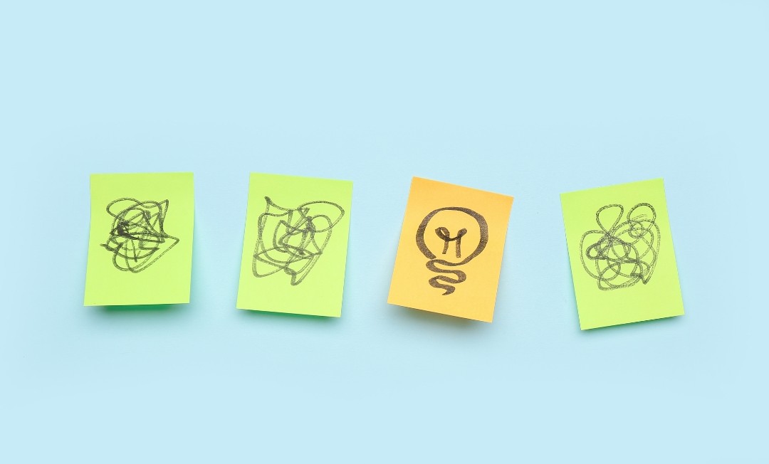 Sales enablement tools Sticky notes with scribbles and one lightbulb idea